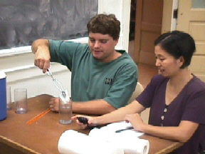 Students removing the paper towel from the glass